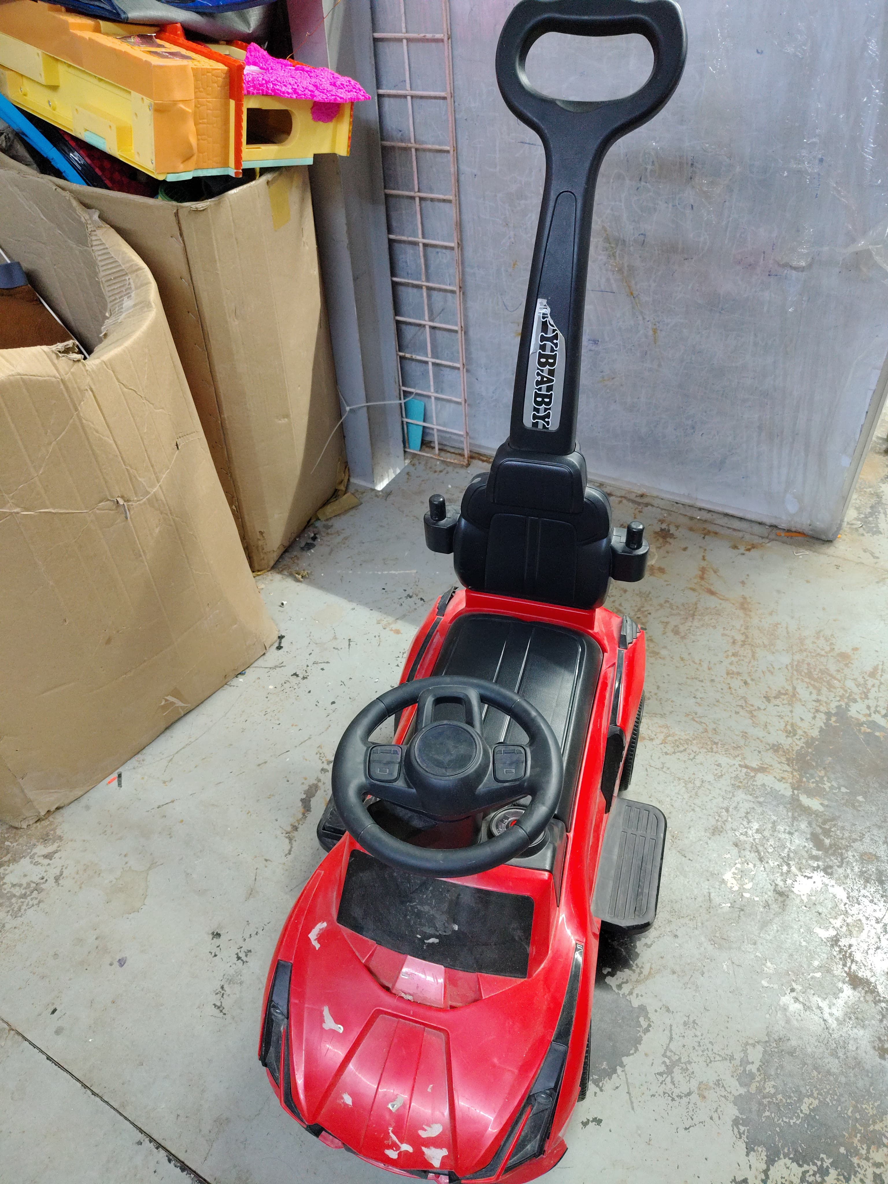 Red ride-on car with parent handle